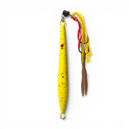 Ocean Angler Fish-Finger metal jig in yellow with black speckles, featuring an assist hook and yellow skirt.